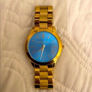 Gold Michael Kors watch with aquatic blue face